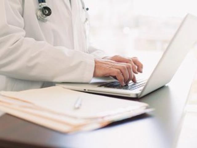 medical professional using laptop