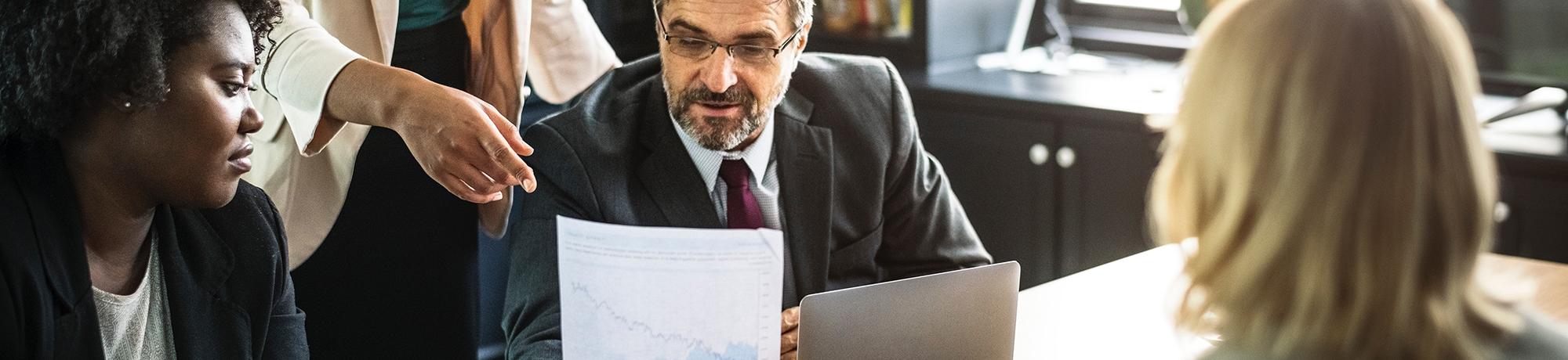 group of colleagues looking at a financial report