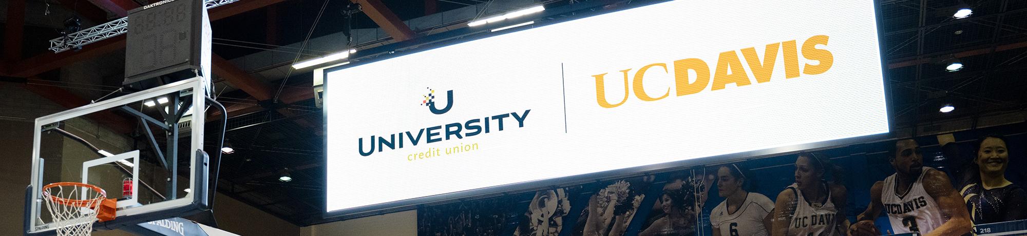 Photo of basketball scoreboard with UCU logo.